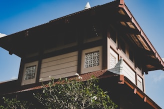 Elegant traditional Tamil style home with royal blue and gold accents under a clear sky.