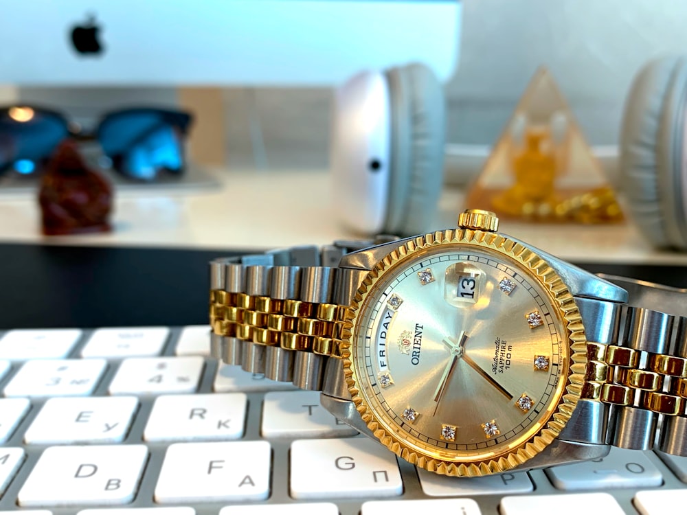 round gold-colored analog watch with band
