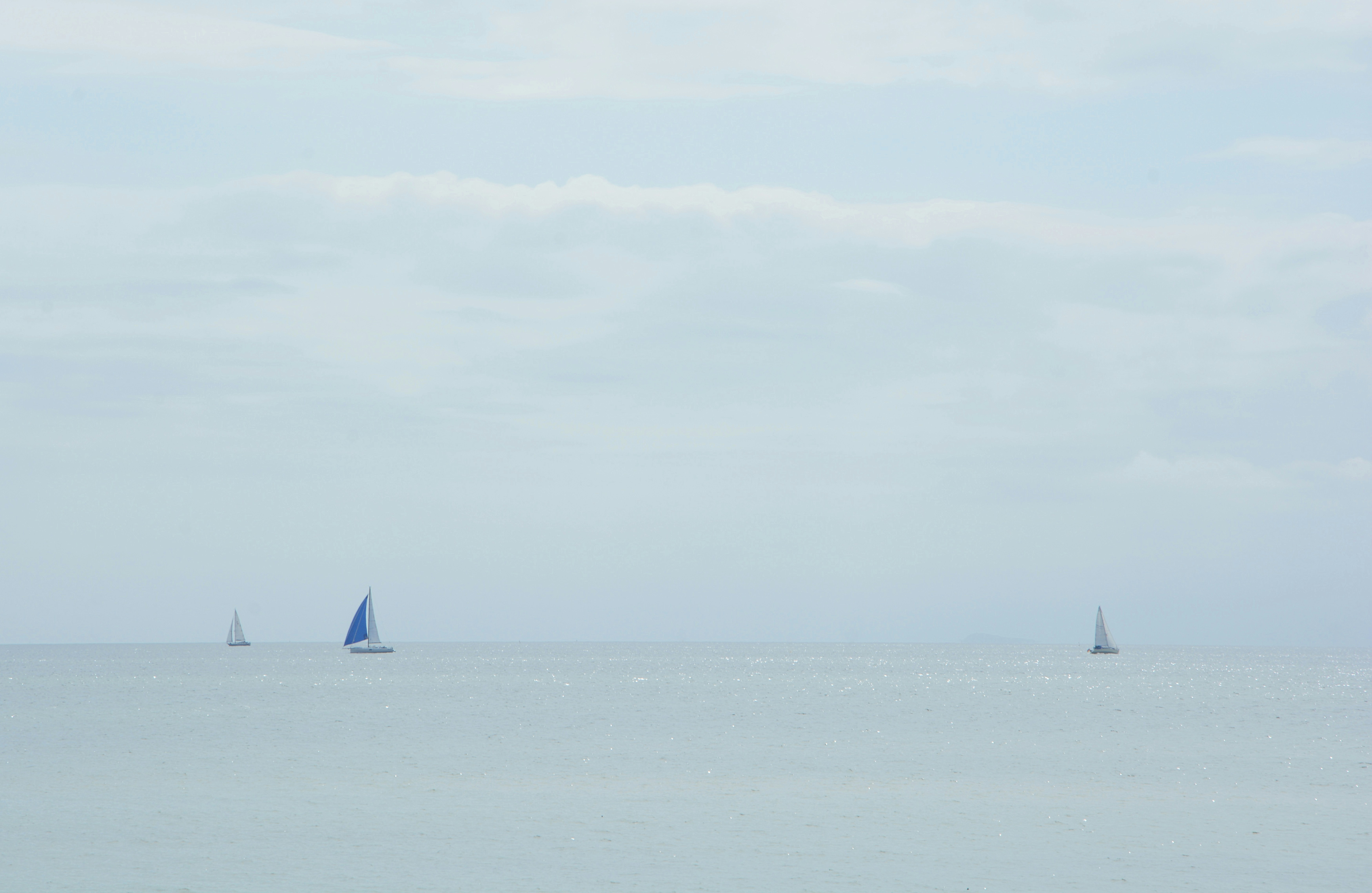 sailboats on calm water at daytime