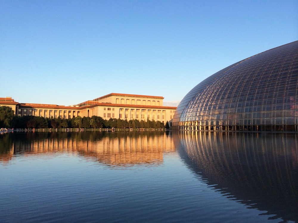 a large building sitting next to a body of water