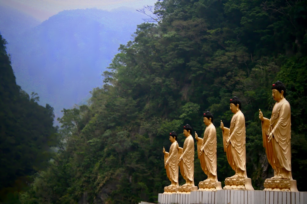 six standing man statues
