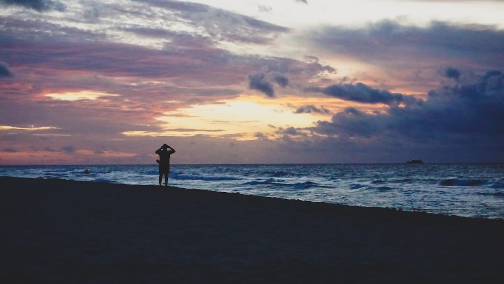 person standing in seashore