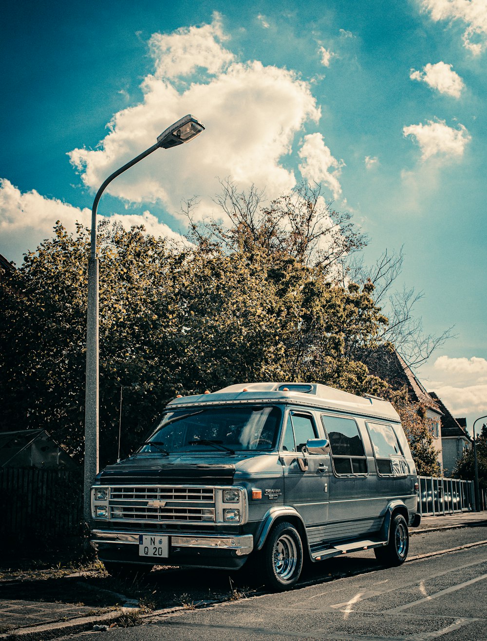 blue Chevrolet vehicle beside street light