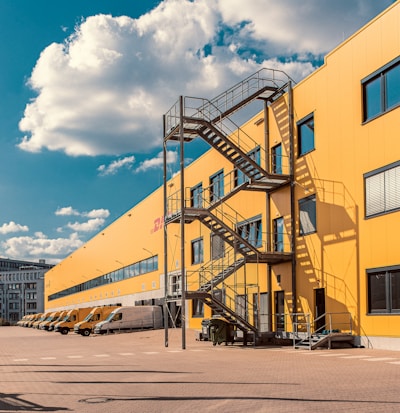 gray metal staircase on orange DHL building