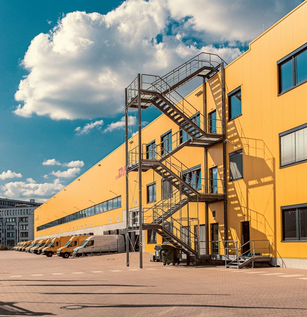 gray metal staircase on orange DHL building