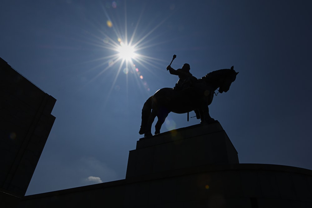 man on horse monument under the sun