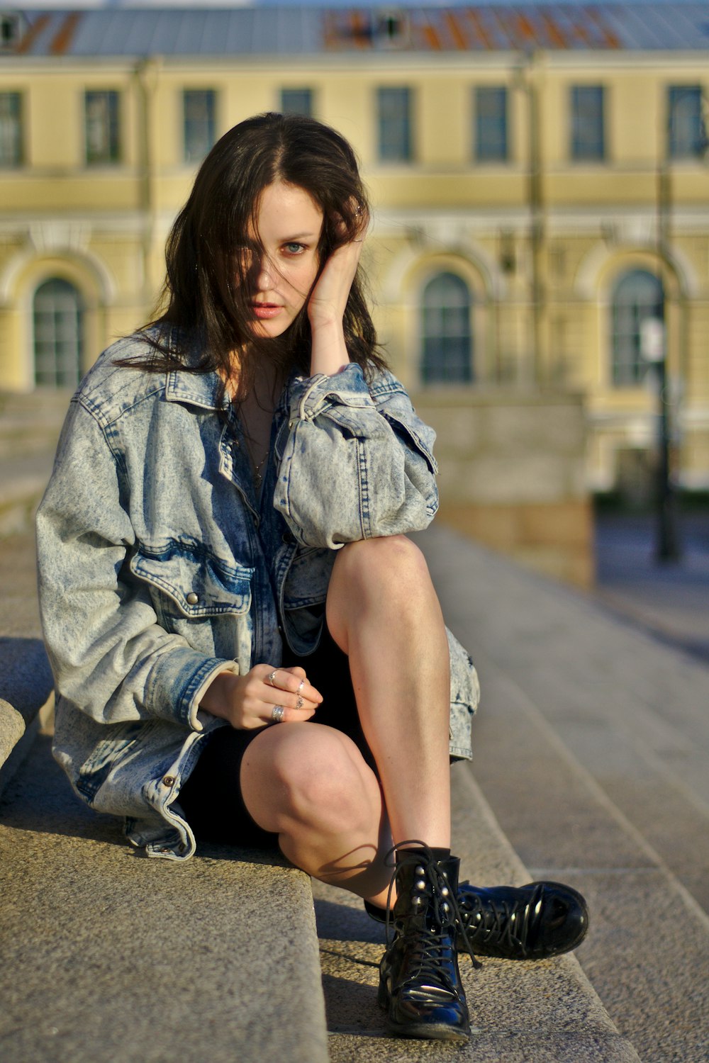 woman sitting on gray stairs