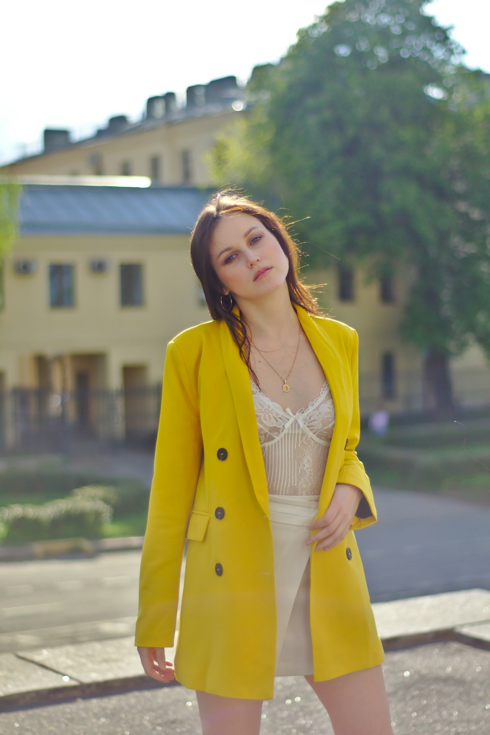 woman wears yellow topcoat