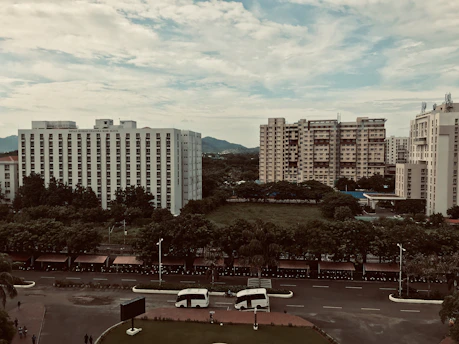 A scenic view of Bandung city with lush greenery and modern vehicles ready for a city tour.
