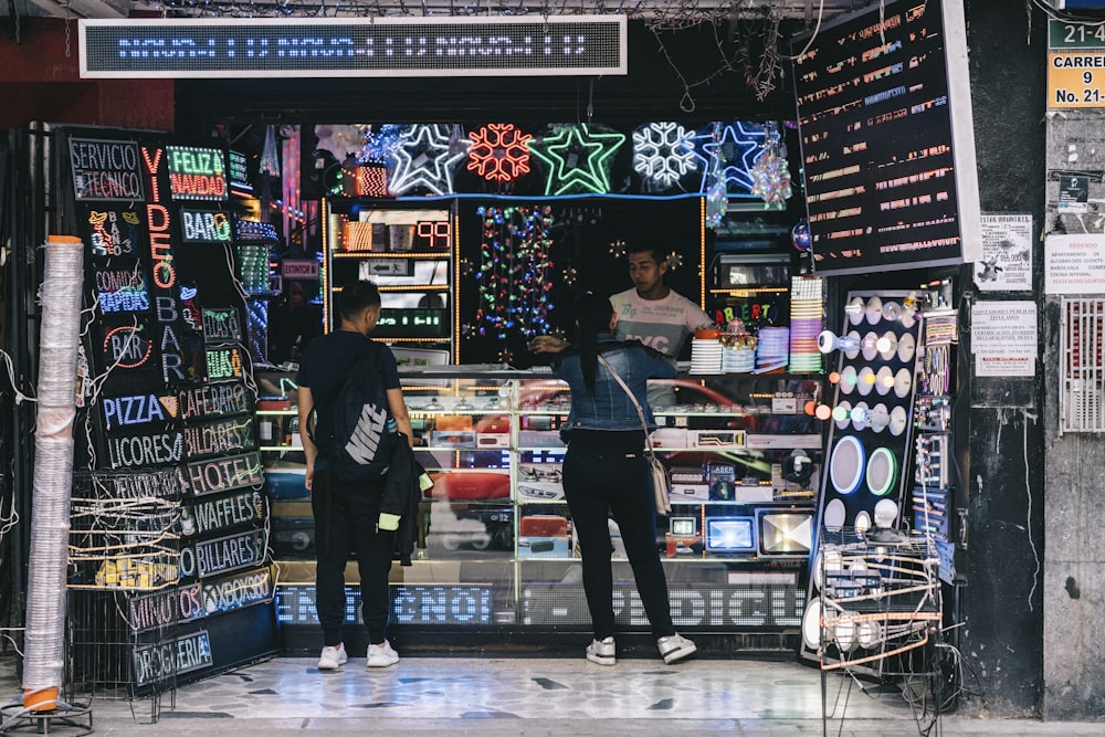 man and woman standing near display cabinet