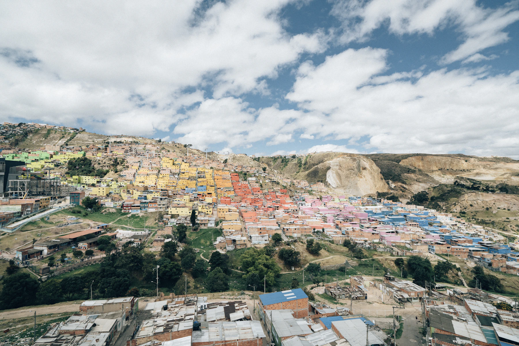 Bogotá's colourful hillside neighbourhoods and modern skyline seen from above