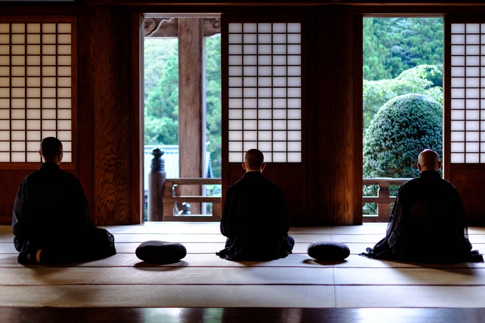 a group of people sitting on top of a floor