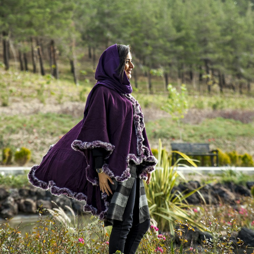 woman standing front of flower field at daytime