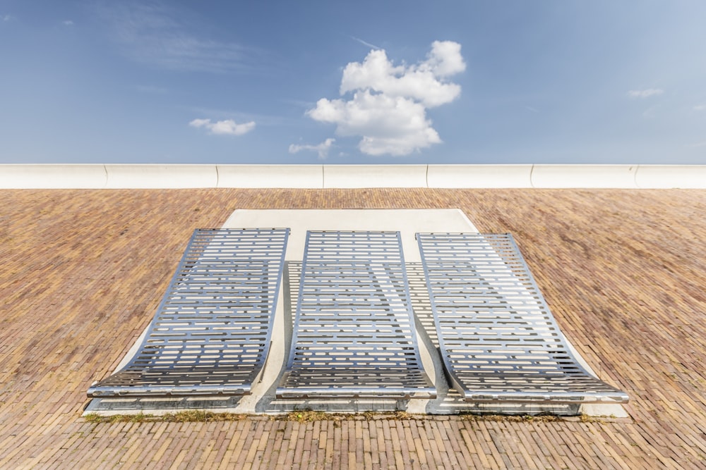 tree gray deck chairs under blue sky