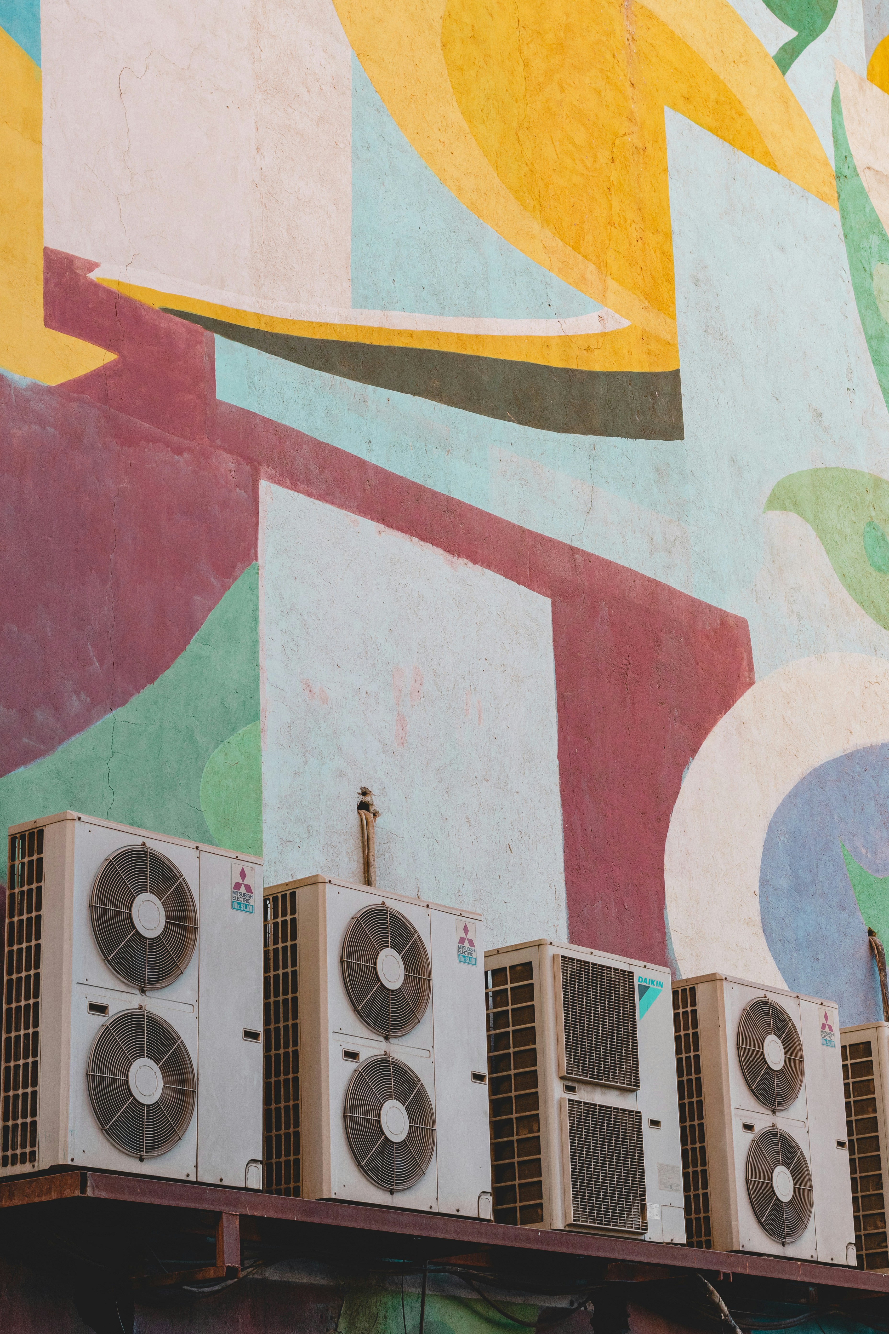 Patterns of the wall of the Bahman cinema and a row of split air conditioners. 