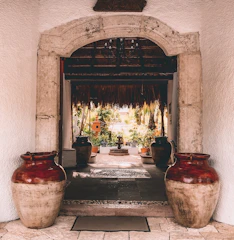 Hospitality entryway featuring layered brick patterns and soft tropical shadows.