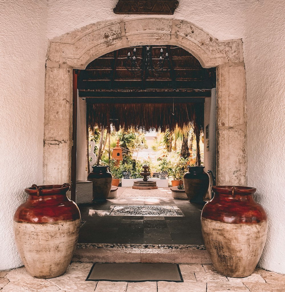 two red-and-beige clay pots