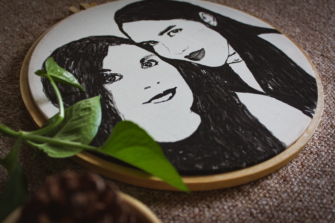 two women sketch on plate decor