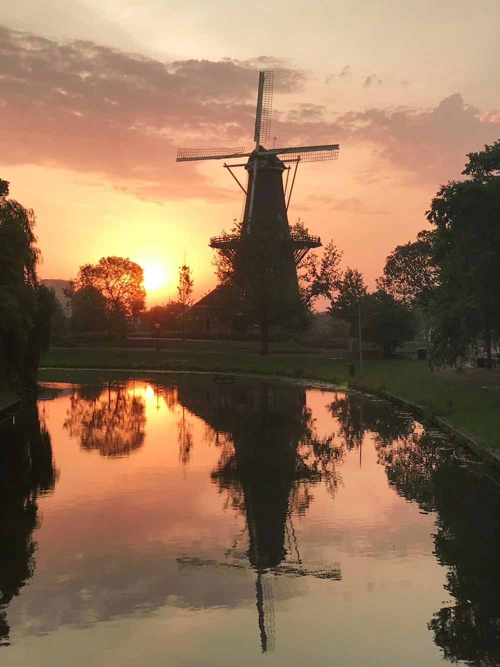 body of water beside wind mill