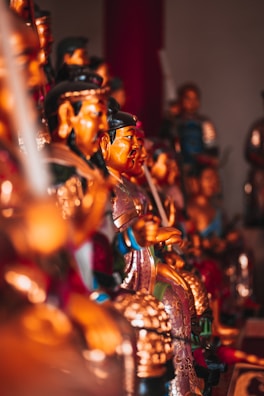 A set of antique porcelain figurines arranged gracefully on a glass shelf, each telling its own story.