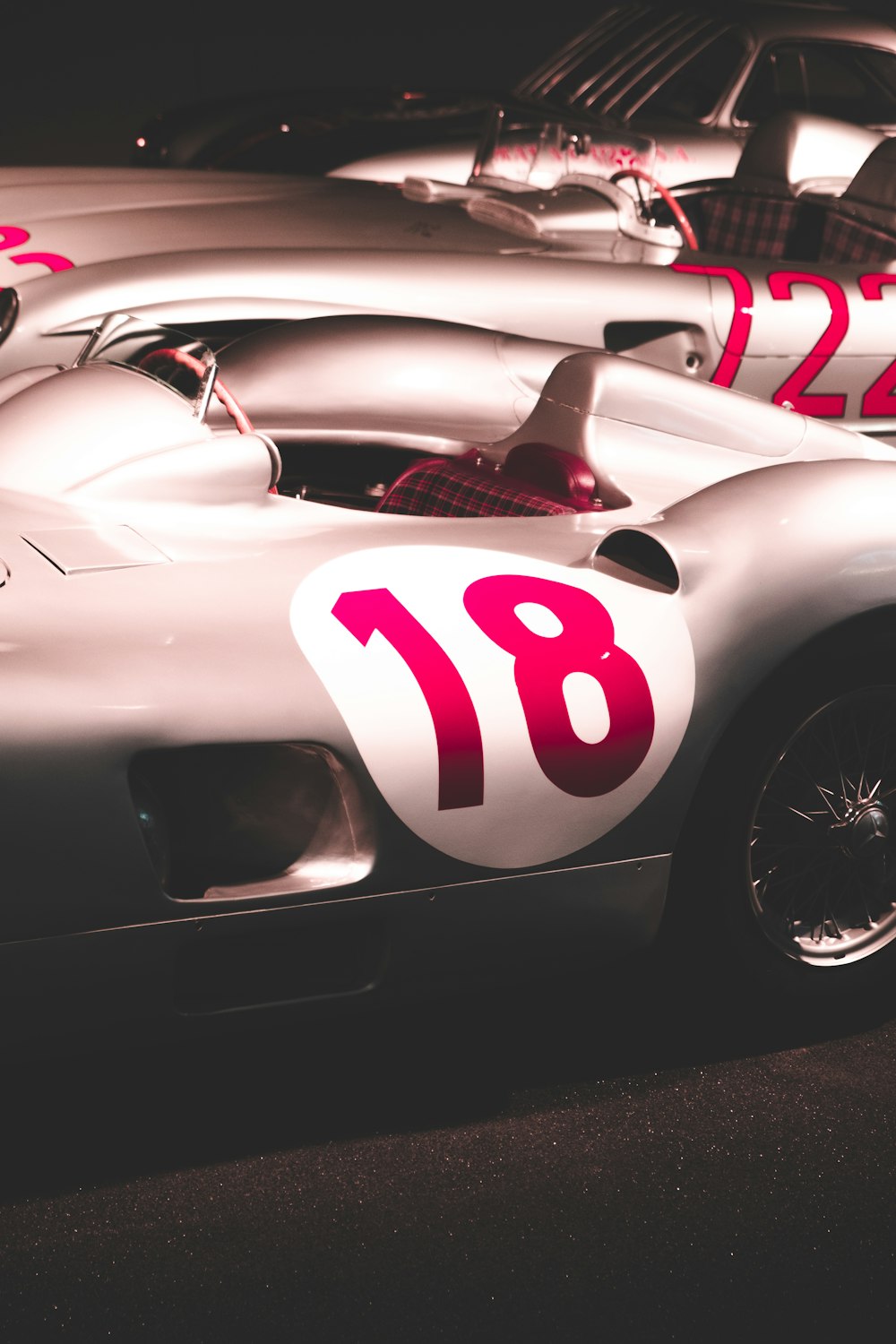a row of racing cars with numbers painted on them