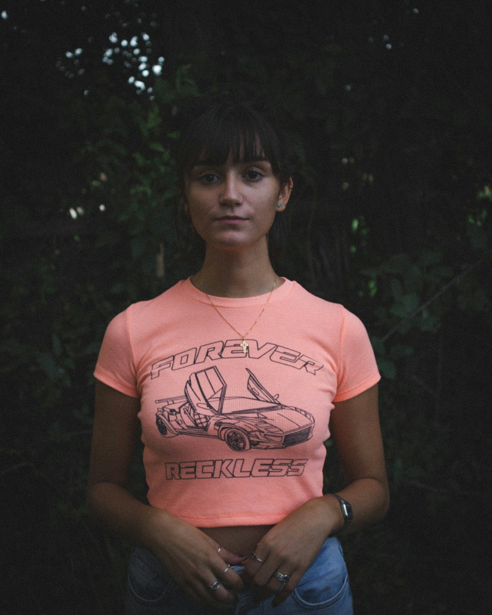 a woman standing in front of some trees