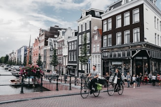 Guests enjoying a relaxed bike tour through the charming Jordaan district on a sunny day.