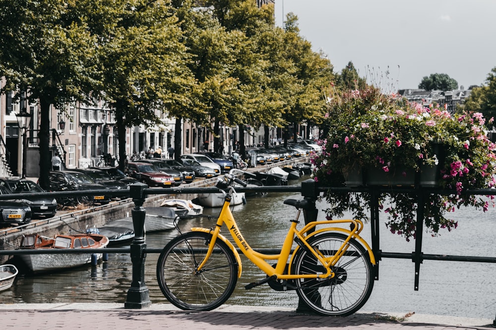 yellow commuter bike parked beside metal handrail