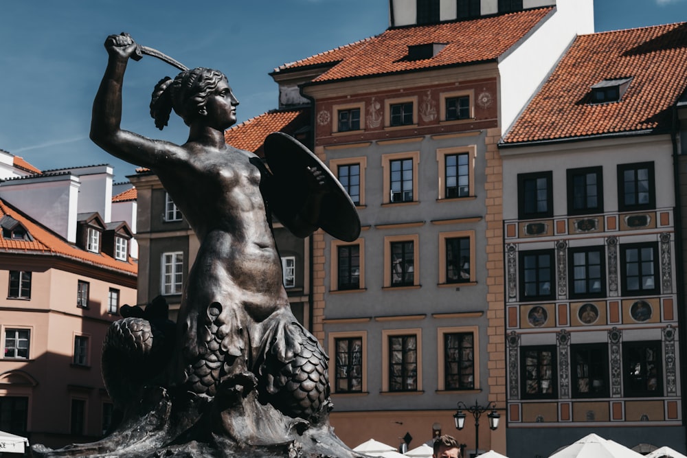 man holding sword and shield statue