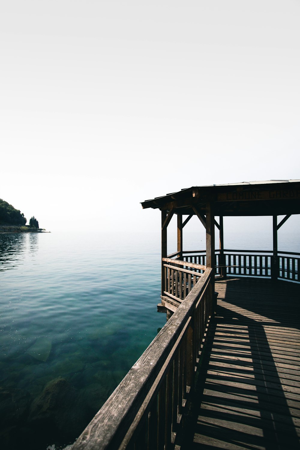 gray wooden beach dock viewing blue sea