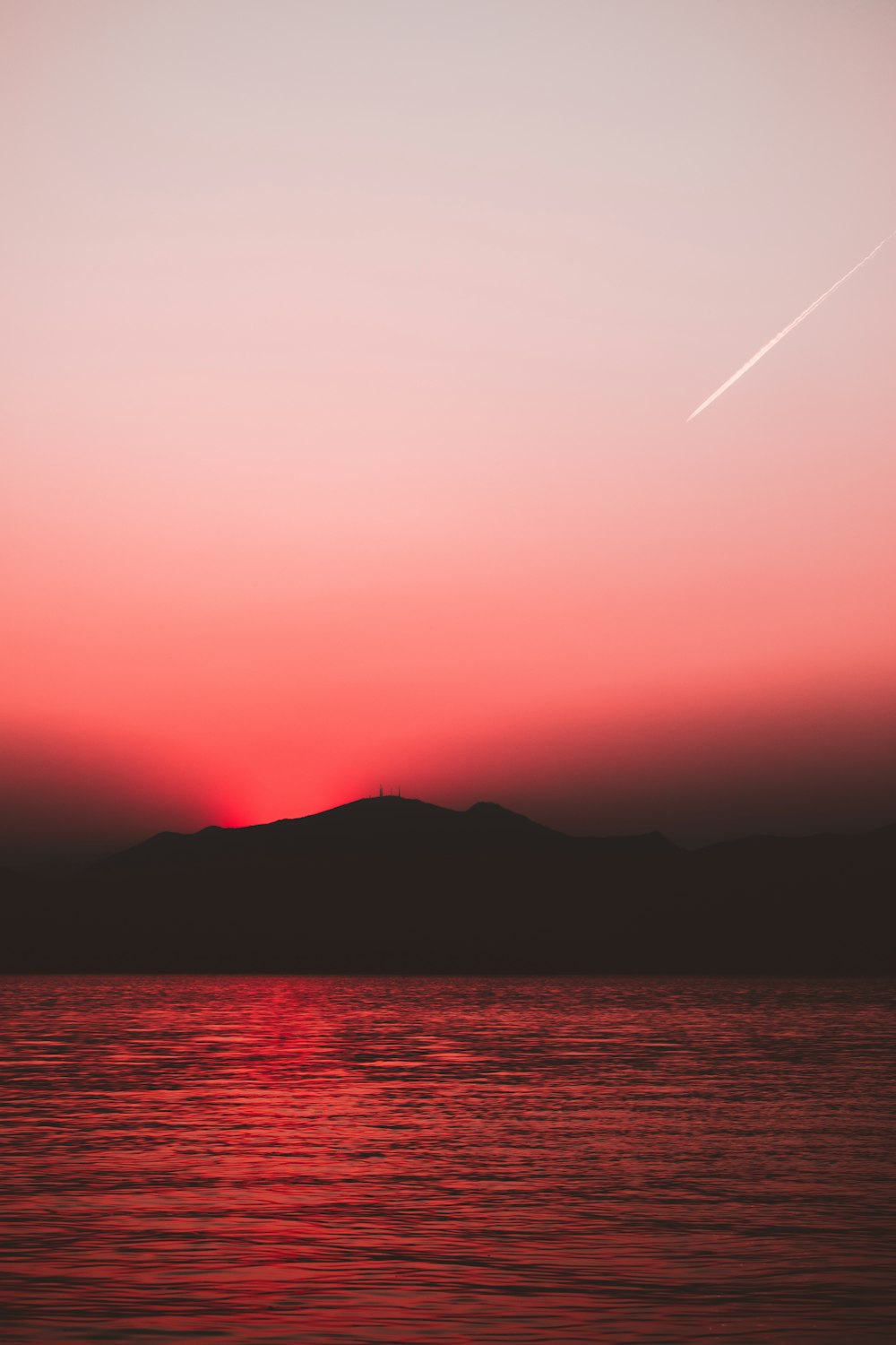 silhouette photography of body of water