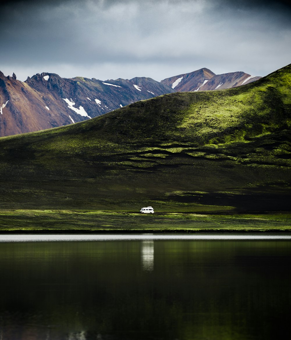 aerial photography of white vehicle and mountain