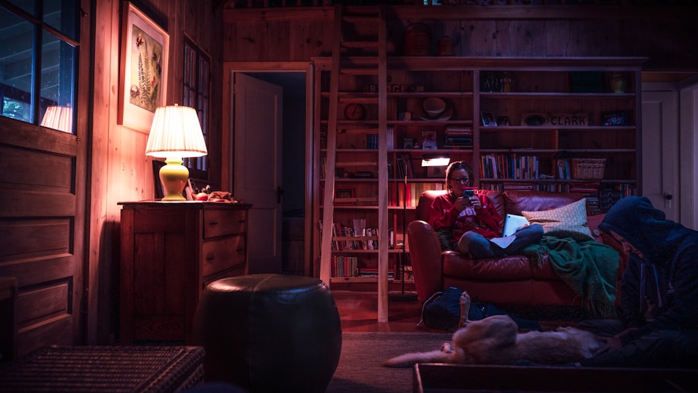 woman sitting on red couch during night time