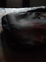 Sunlight casting shadows on a textured fabric detail from a modern backpack piece