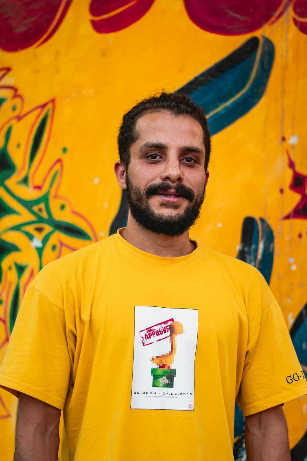 man near yellow and blue wall