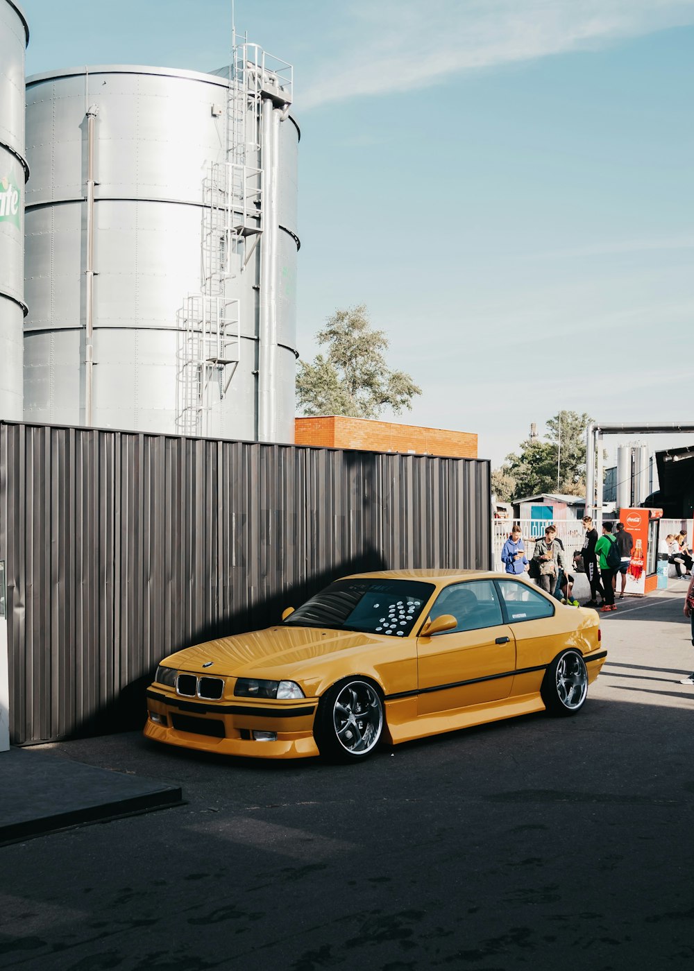 yellow BMW coupe park near wall