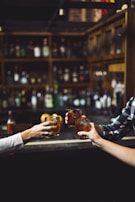 three person holding clear drinking glasses