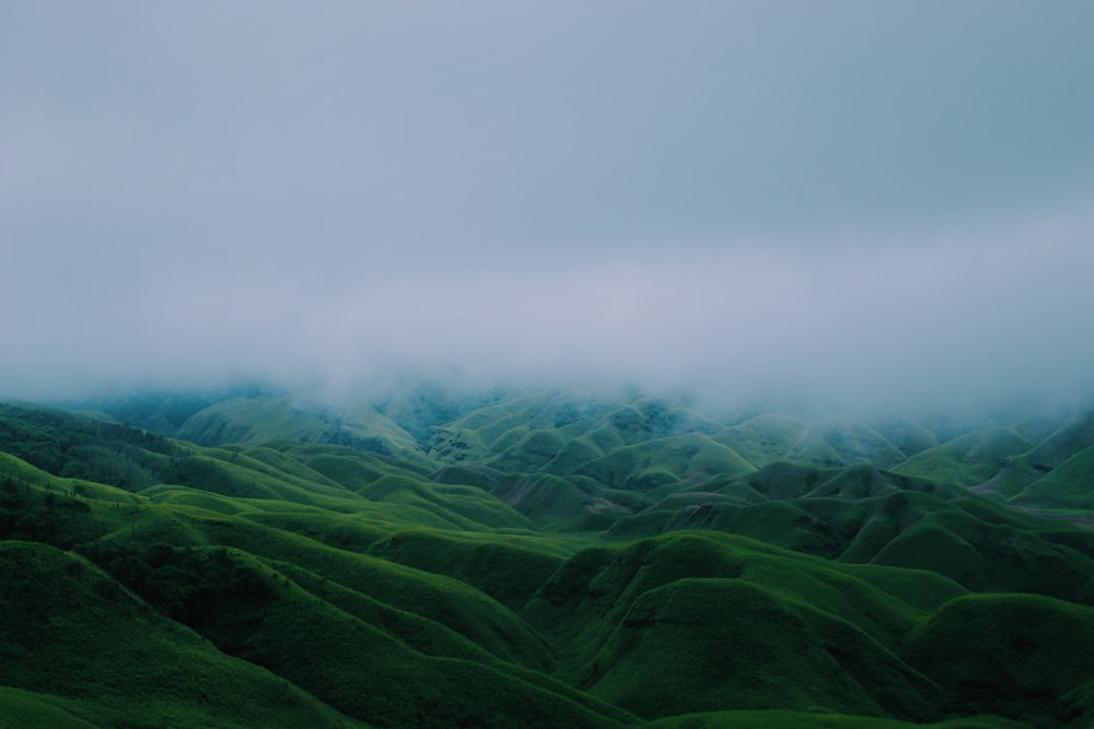 green mountains under cloudy sky