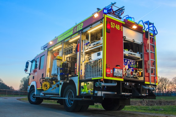 red firetruck on grass during daytime