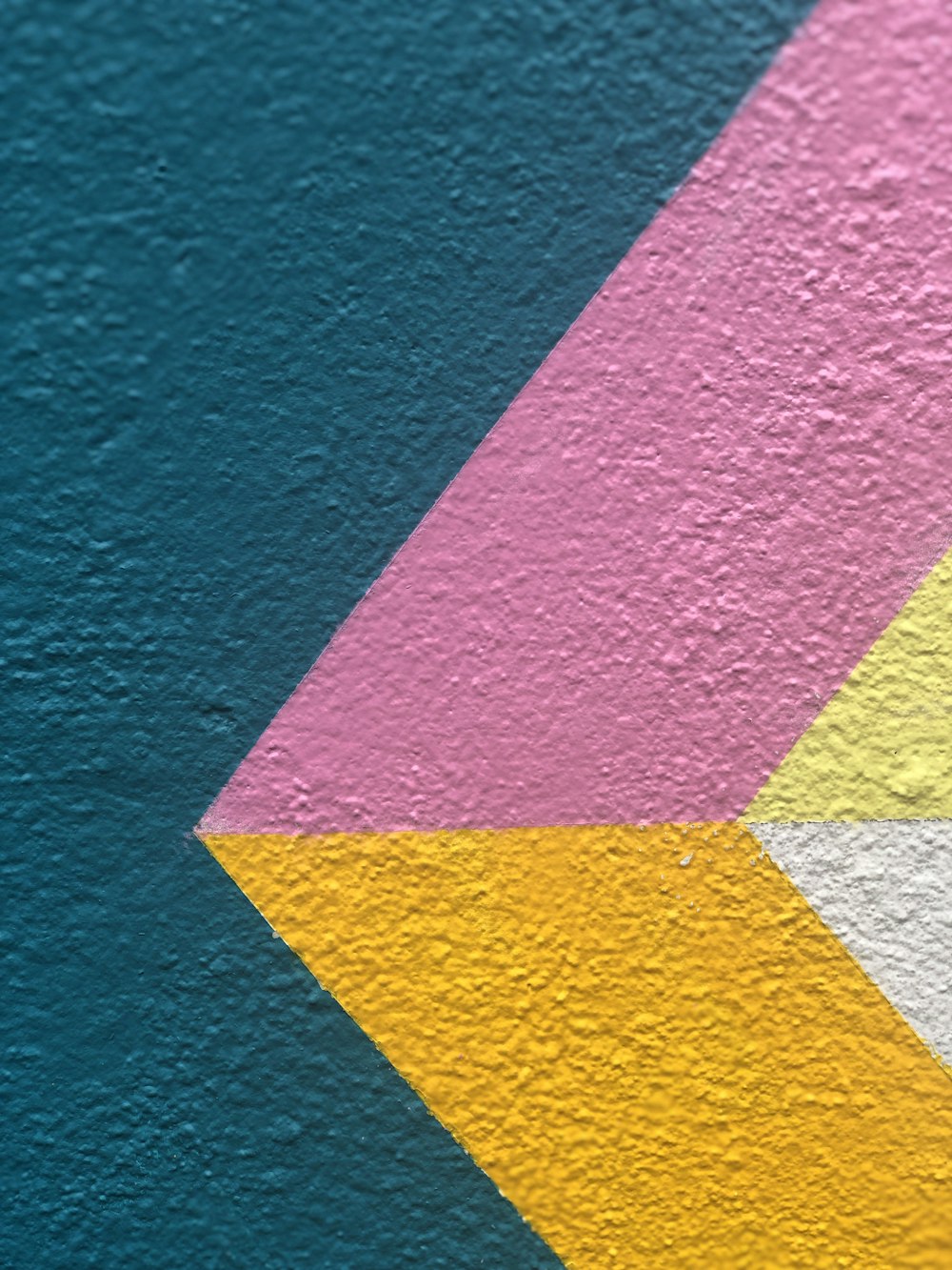 a close up of a wall with a colorful design on it