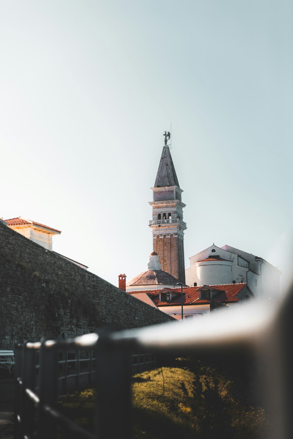 a view of a building with a clock tower in the background