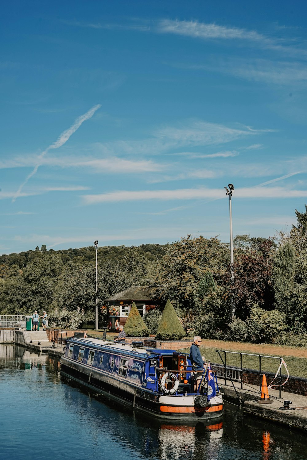 blue and white passenger boat besides black metal fence