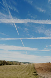 Wide shot of a network trunk line stretching across a rural landscape
