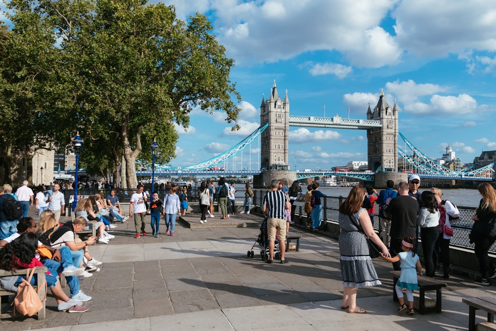 group of people standing near bridge