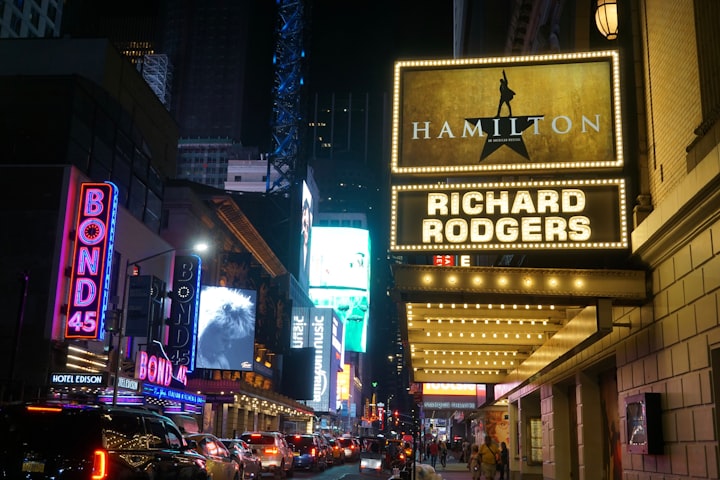An image outside a theater showing Hamilton the Musical
