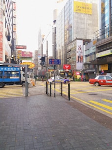 A busy city street with multiple cars featuring vibrant stick2earn ads.