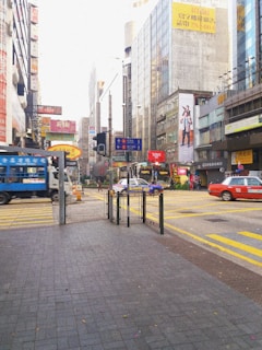 A vibrant city street with multiple Uber vehicles showcasing various brand advertisements.