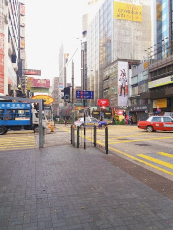 A vibrant city street with multiple trucks showcasing colorful brand advertisements.