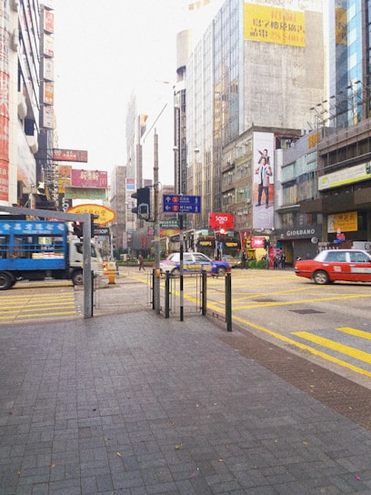 A vibrant city street with multiple Uber vehicles showcasing various brand advertisements.