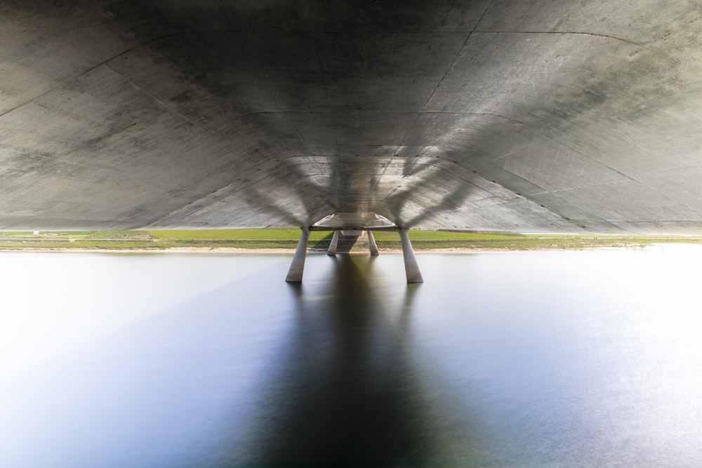 a large concrete structure with water underneath it
